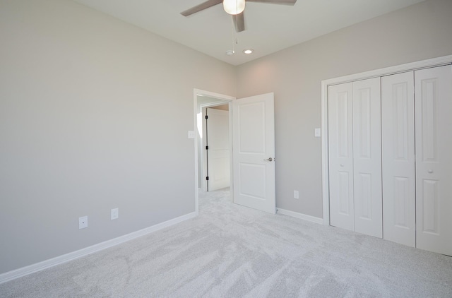 unfurnished bedroom with a closet, ceiling fan, and light colored carpet