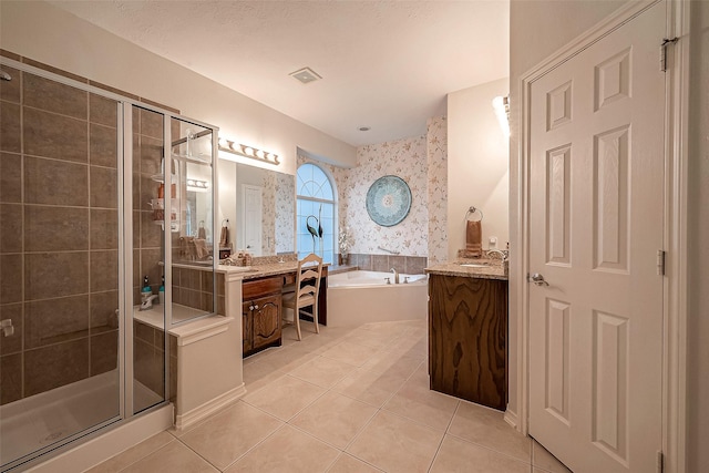 bathroom with tile patterned floors, vanity, and independent shower and bath