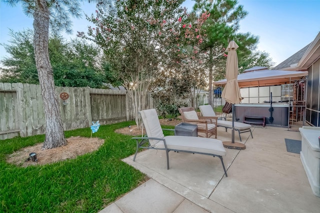 view of patio / terrace featuring a gazebo and a hot tub