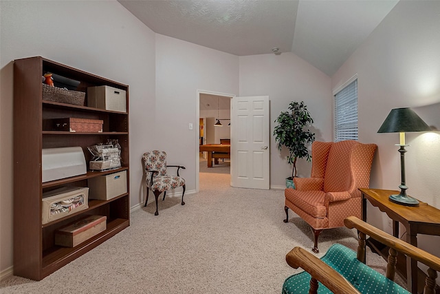 sitting room featuring lofted ceiling and carpet floors