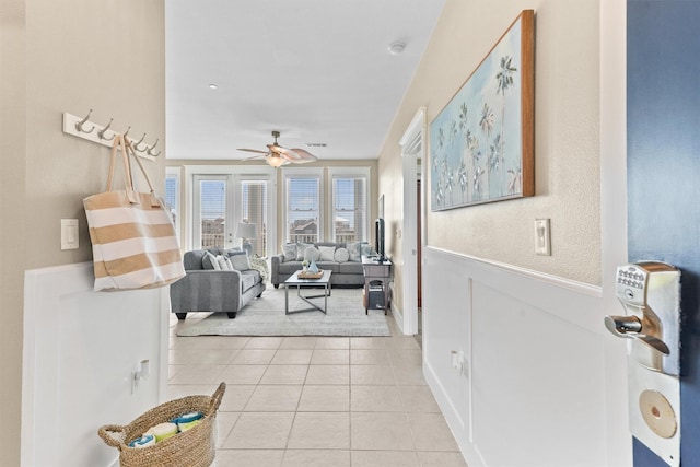 living room featuring ceiling fan and light tile patterned flooring