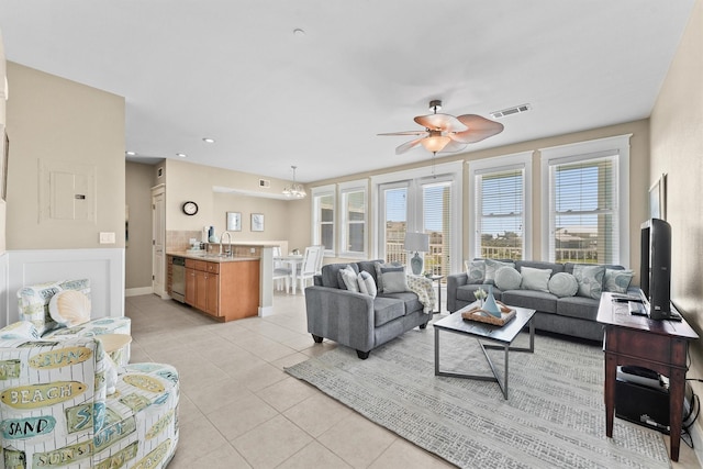 living room with light tile patterned floors, ceiling fan, and sink