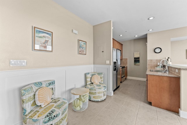 sitting room with light tile patterned floors and sink