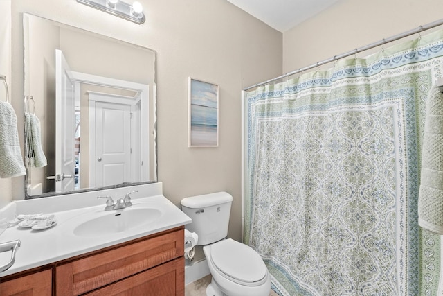 bathroom with vanity, toilet, and walk in shower