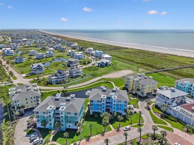 drone / aerial view with a water view and a beach view