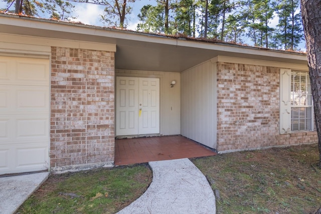 view of exterior entry with a garage