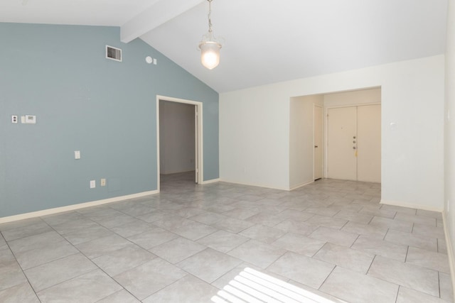 tiled empty room with beamed ceiling and high vaulted ceiling