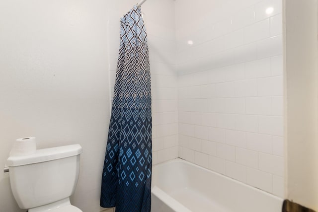 bathroom with shower / tub combo with curtain and toilet