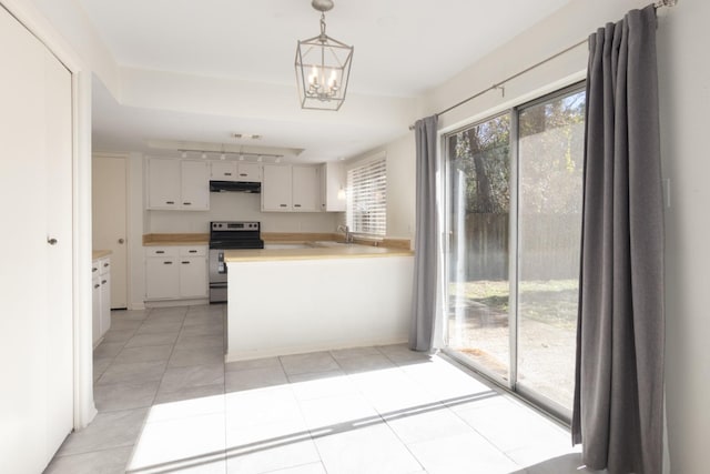 kitchen with light tile patterned floors, a notable chandelier, white cabinetry, hanging light fixtures, and stainless steel range with electric cooktop