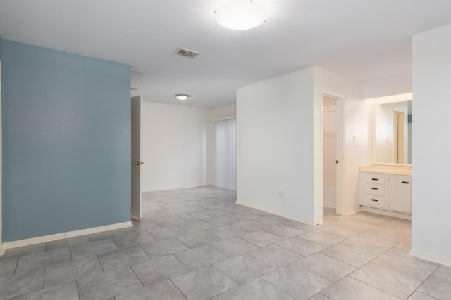 spare room featuring light tile patterned floors