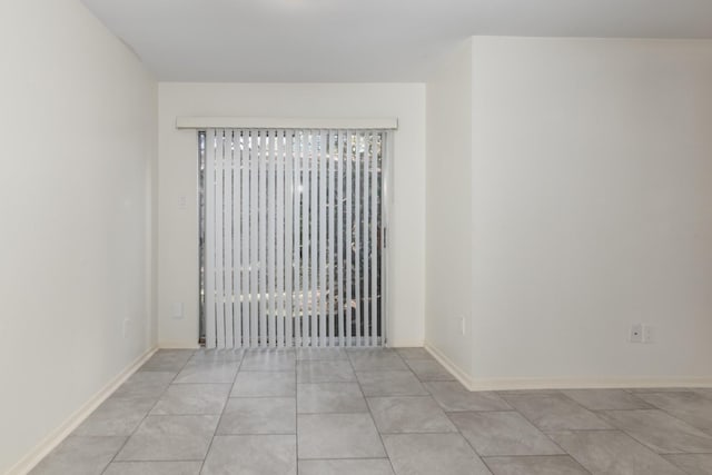 spare room with light tile patterned flooring