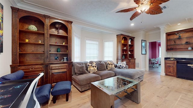 living room featuring light hardwood / wood-style flooring, ceiling fan, and crown molding