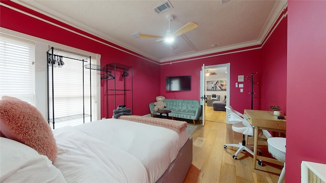 bedroom with hardwood / wood-style floors, ceiling fan, and crown molding