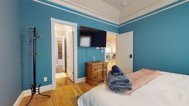 bedroom featuring hardwood / wood-style floors and ornamental molding