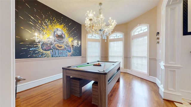 game room featuring hardwood / wood-style flooring, an inviting chandelier, and billiards