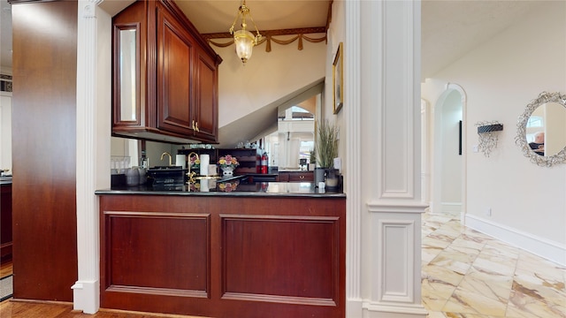 bar featuring lofted ceiling and ornate columns