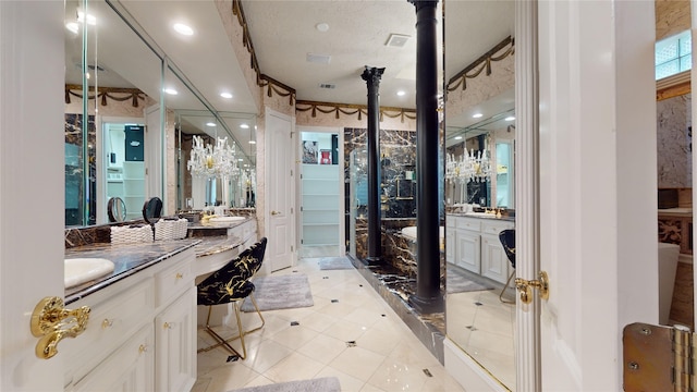 bathroom featuring a textured ceiling and vanity