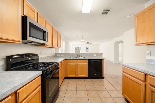 kitchen with ceiling fan, sink, kitchen peninsula, light tile patterned floors, and black appliances