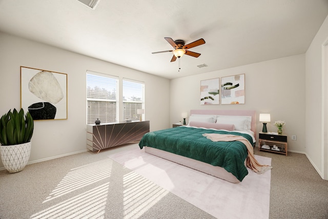 bedroom with ceiling fan and light carpet