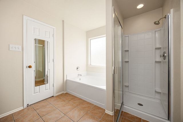 bathroom with separate shower and tub and tile patterned flooring