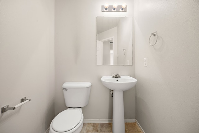 bathroom featuring sink and toilet