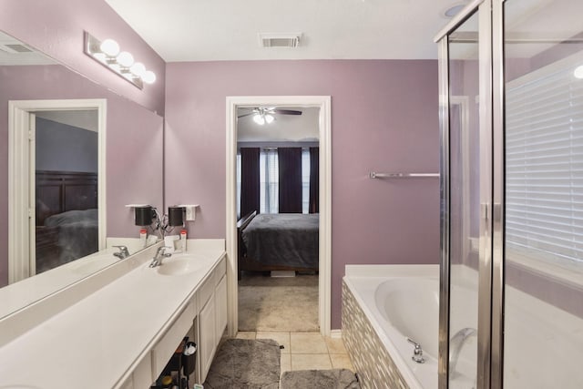 bathroom with vanity, tile patterned flooring, and a bathtub