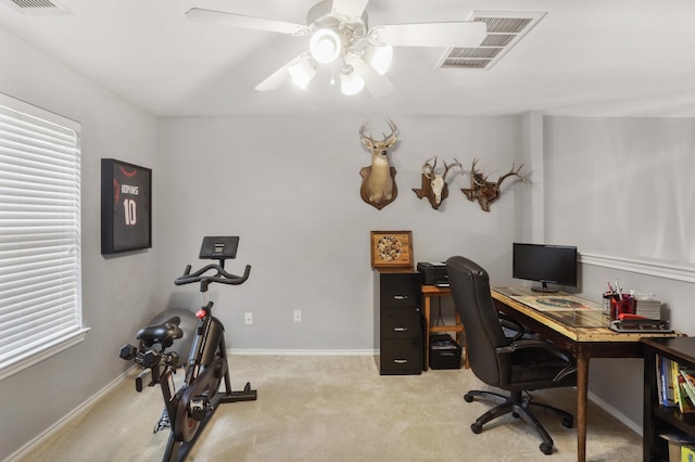 carpeted office space featuring ceiling fan