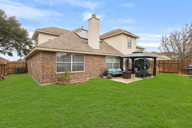 back of property featuring a gazebo, an outdoor hangout area, a yard, and a patio