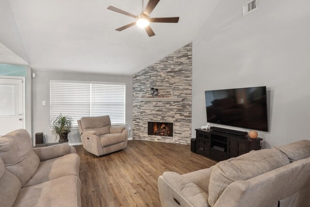 living room with a fireplace, light hardwood / wood-style flooring, high vaulted ceiling, and ceiling fan