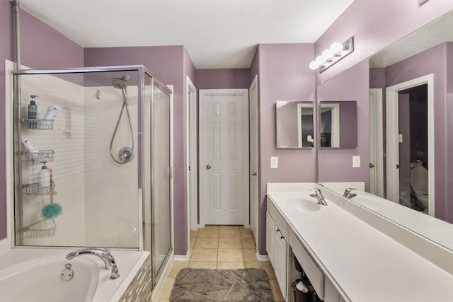 full bathroom with vanity, tile patterned floors, toilet, and separate shower and tub