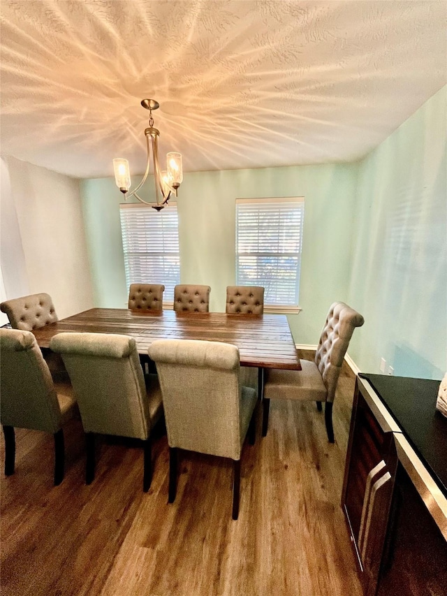 dining room with light wood-type flooring and a chandelier