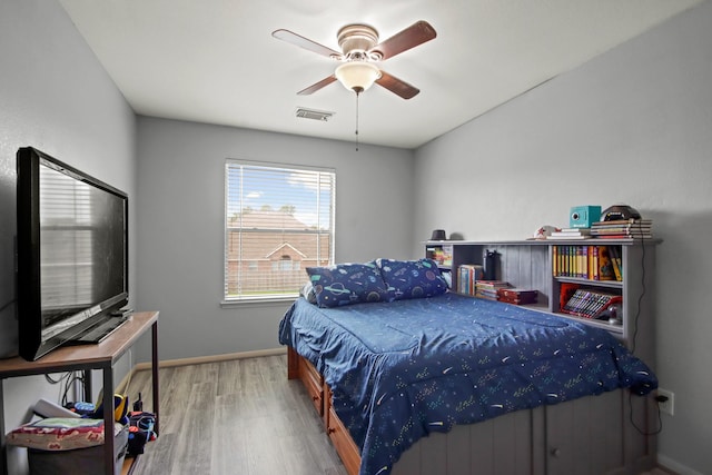 bedroom with hardwood / wood-style flooring and ceiling fan