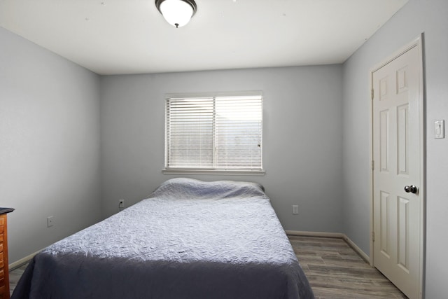 bedroom with dark hardwood / wood-style floors