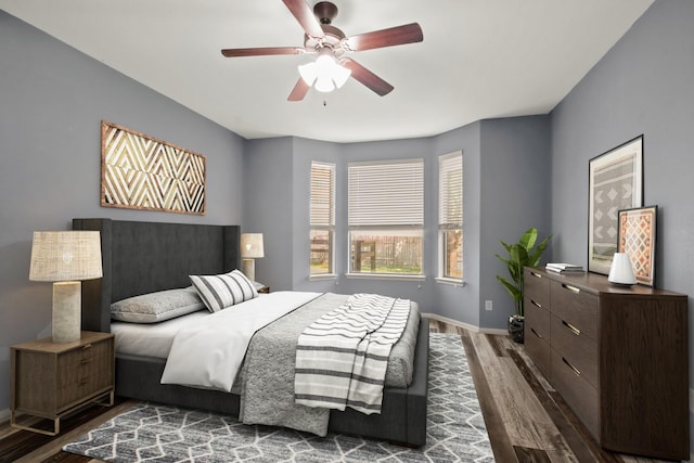 bedroom featuring ceiling fan and dark wood-type flooring