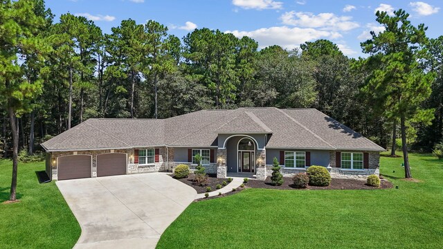 single story home with a front yard and a garage