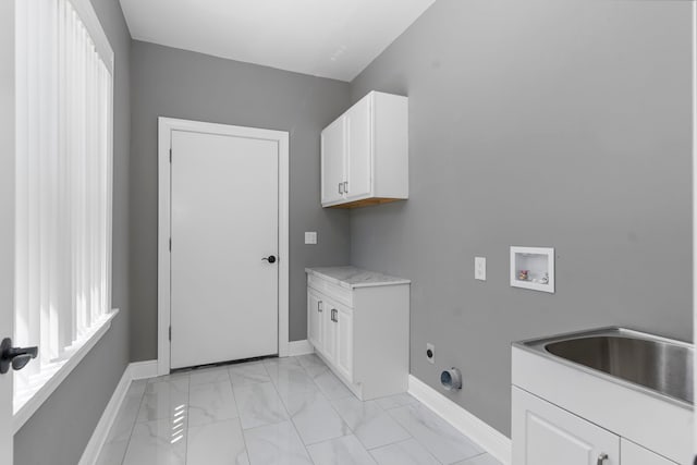 laundry room with sink, hookup for an electric dryer, hookup for a washing machine, and cabinets