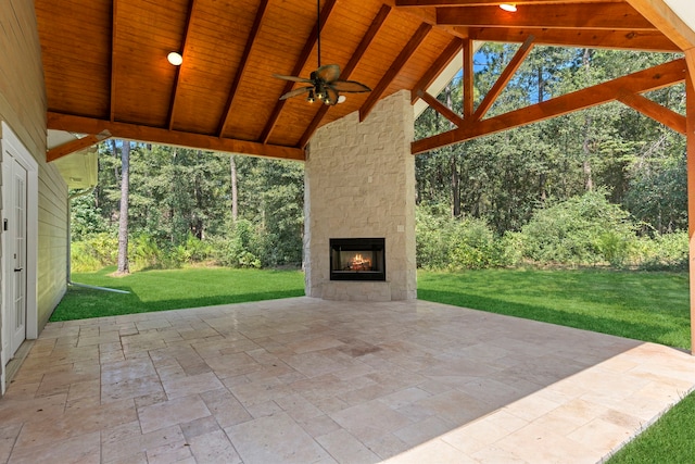 view of patio with ceiling fan and an outdoor stone fireplace