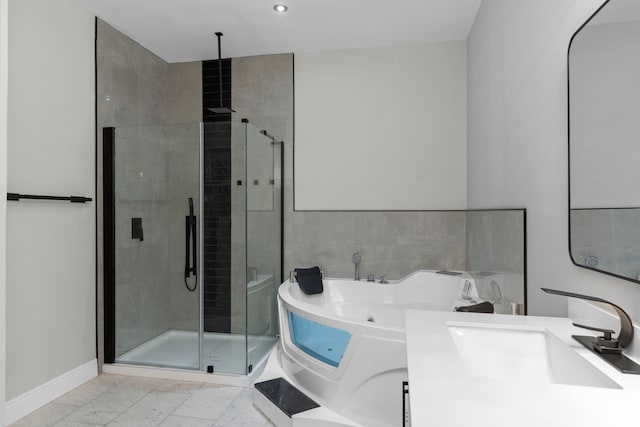 bathroom with shower with separate bathtub and vanity