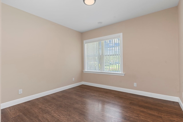 empty room featuring dark hardwood / wood-style flooring