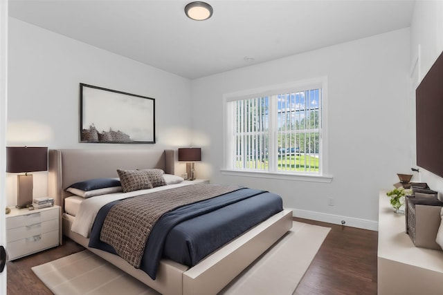 bedroom with dark hardwood / wood-style floors