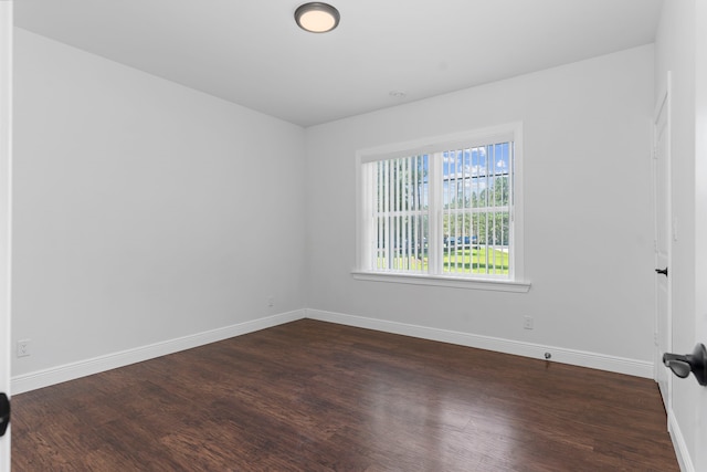 unfurnished room featuring dark hardwood / wood-style flooring