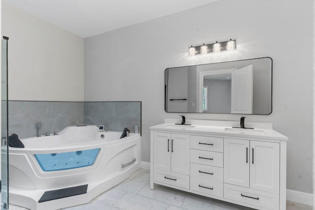 bathroom with a washtub and vanity