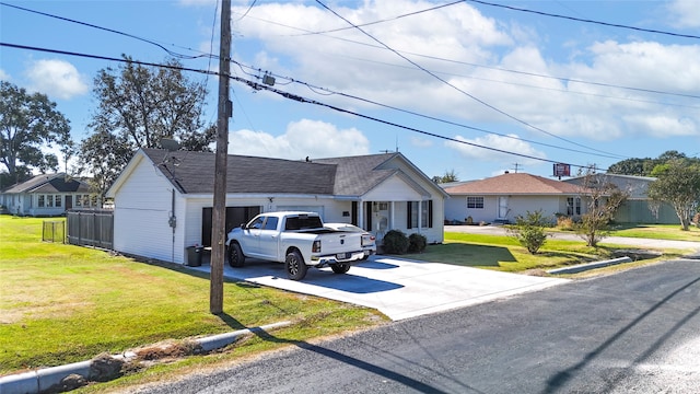 ranch-style home featuring a front yard and a garage