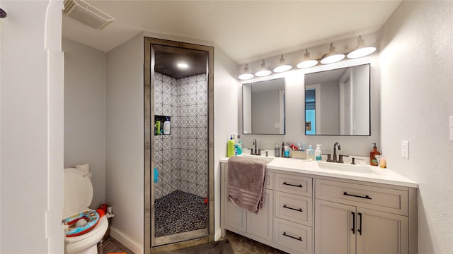 bathroom with vanity, toilet, and an enclosed shower