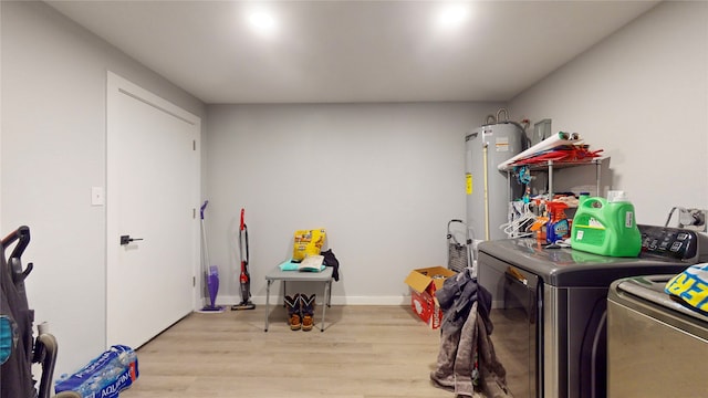 washroom with independent washer and dryer, light wood-type flooring, and electric water heater