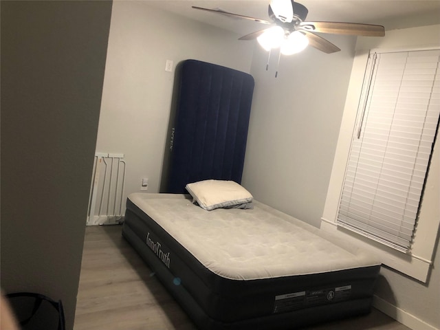 bedroom with light wood-type flooring and a ceiling fan