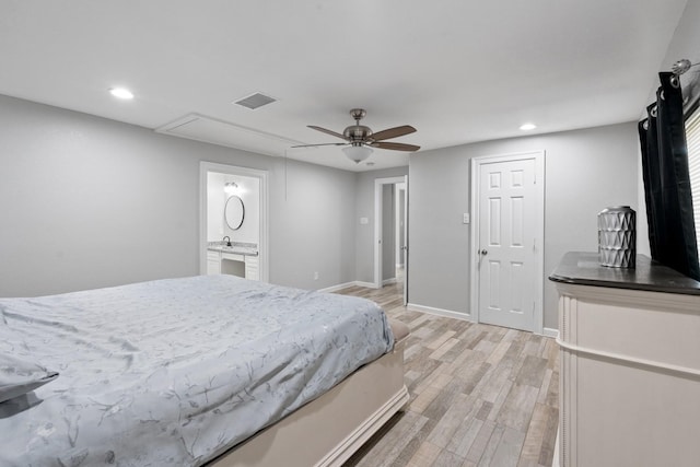 bedroom featuring connected bathroom, ceiling fan, sink, and light hardwood / wood-style floors