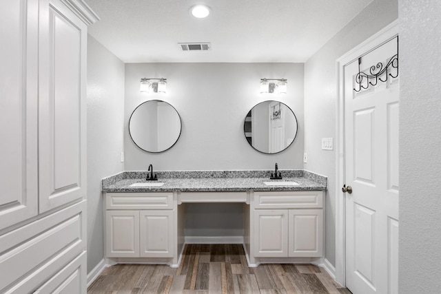 bathroom with vanity and wood-type flooring