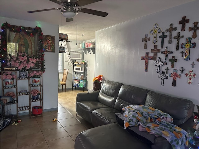 living room with tile patterned flooring, a wall unit AC, and ceiling fan