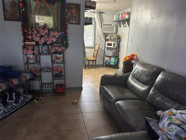 living room featuring tile patterned floors and a wall mounted AC